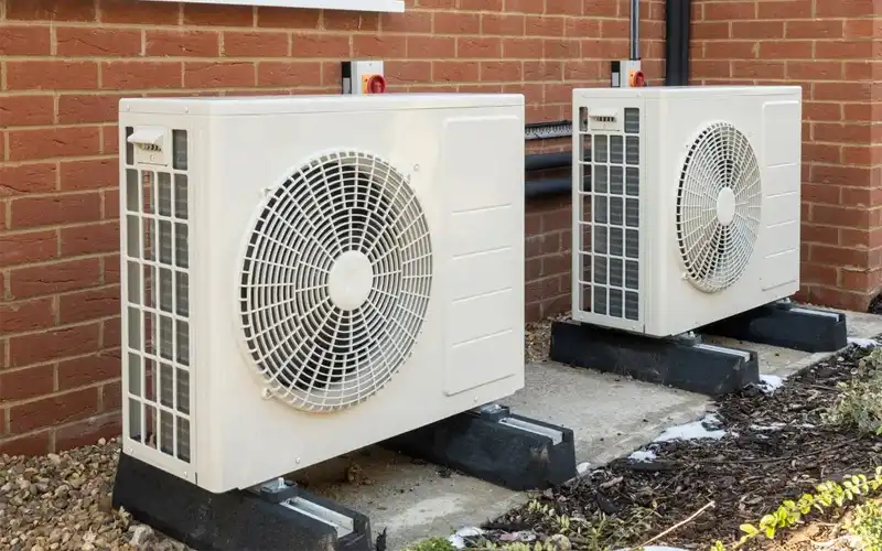 Two air source heat pump units outside.